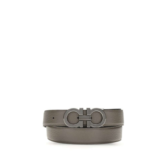 Gray Calf Leather Bos Taurus BeltGancini Belt by Ferragamo is a refined and versatile accessory made of grained leather with reversible, two-tone construction, ideal for adapting to different looks. The Gancini buckle with ruthenium finish features vertic