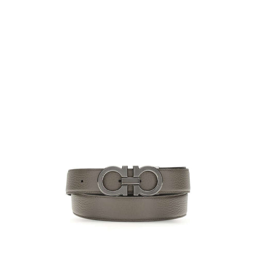 Gray Calf Leather Bos Taurus BeltGancini Belt by Ferragamo is a refined and versatile accessory made of grained leather with reversible, two-tone construction, ideal for adapting to different looks. The Gancini buckle with ruthenium finish features vertic