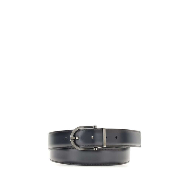 Black Calf Leather Bos Taurus Regular BeltReversible leather Belt by Ferragamo is made of soft calfskin and features a two-tone construction designed to offer maximum versatility. The geometric buckle with ruthenium finish is embellished with the signatur
