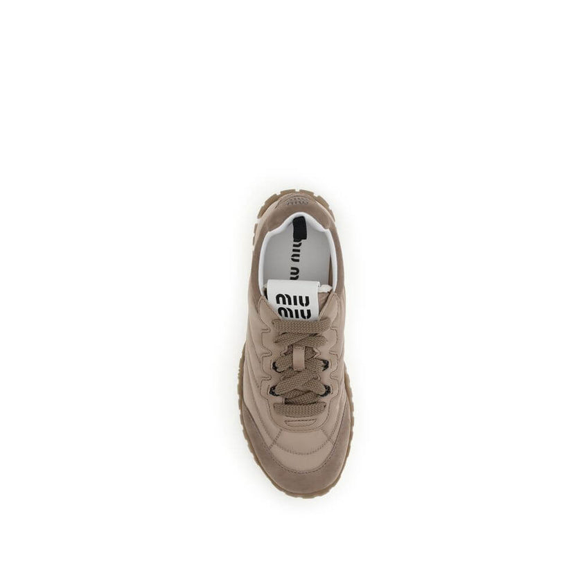 Tyre SneakersMiu Miu’s Tyre Sneakers combine technical materials and refined details in a dynamic, contemporary design. Made of technical fabric and suede, they feature lace-up lacing and fabric and leather lining for optimal comfort. Screen-printed logos