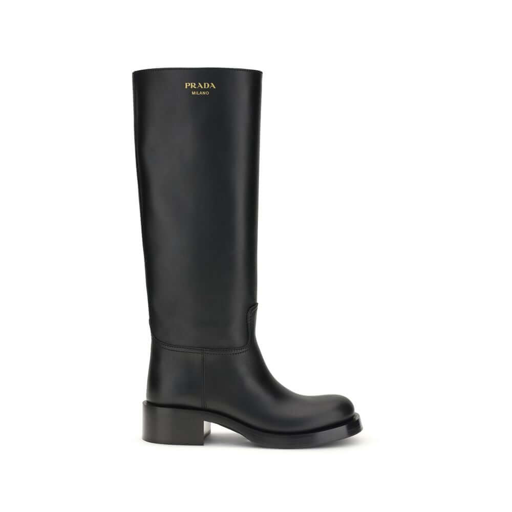 Black Calf Leather Bos Taurus BootsHigh Leather Boots by Prada are made of smooth leather and feature a sleek, essential design. They feature a round toe and are embellished with a laminated printed logo on the side, as well as a printed logo on the insid