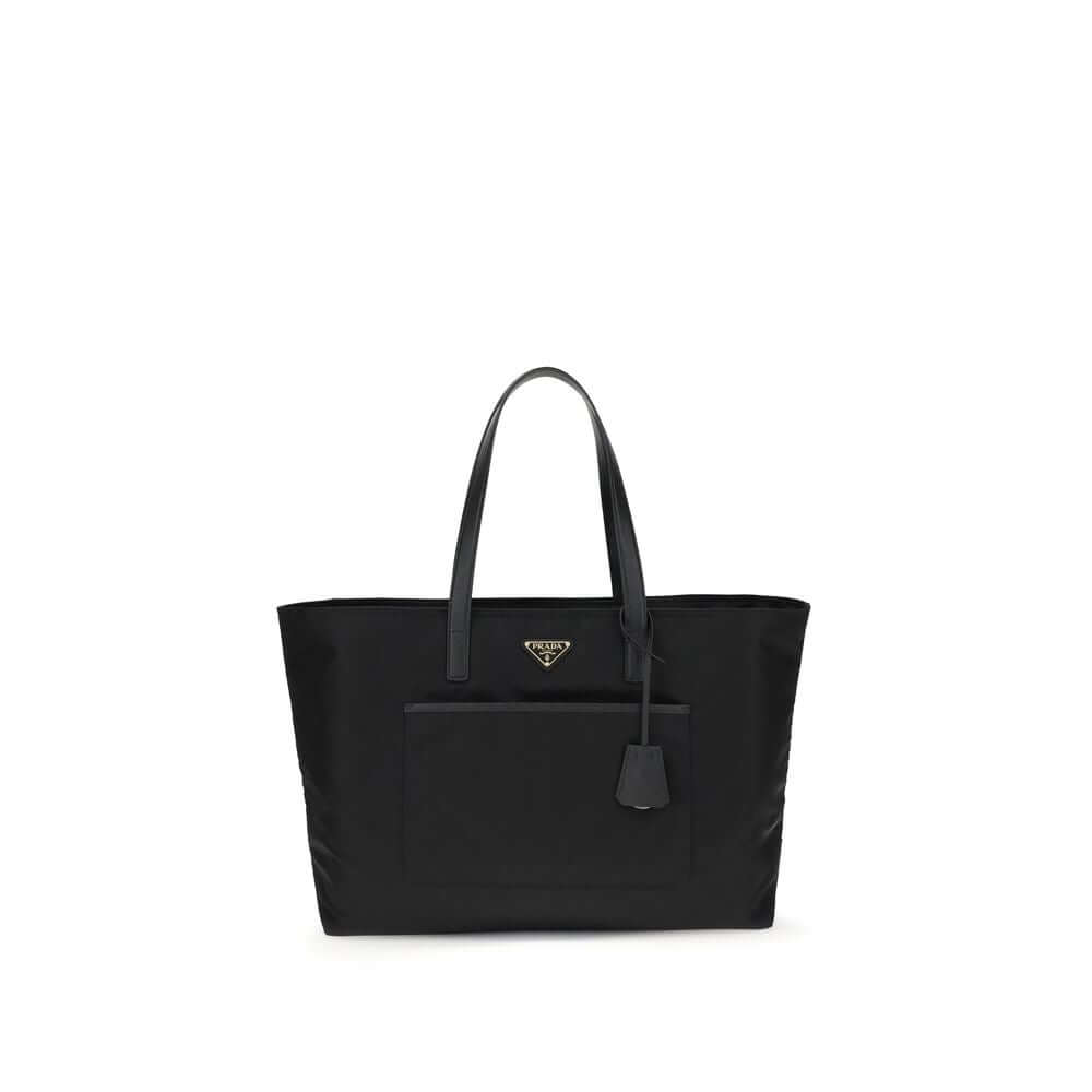 Black Nylon Shoulder BagRe-Nylon Re-Edition 1978 Shoulder Bag by Prada, two flat handles, concealed top zipper closure, interior lining with printed logo, front panel patch pocket, iconic triangular enameled signature brand plaque applied to front. Season