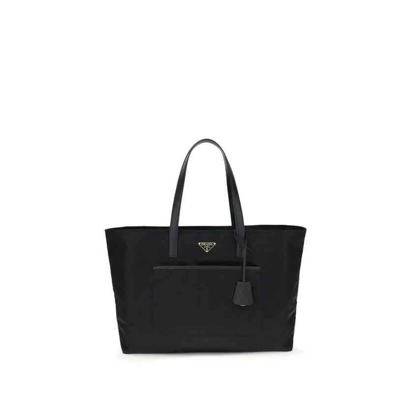Black Nylon Shoulder BagRe-Nylon Re-Edition 1978 Shoulder Bag by Prada, two flat handles, concealed top zipper closure, interior lining with printed logo, front panel patch pocket, iconic triangular enameled signature brand plaque applied to front. Season
