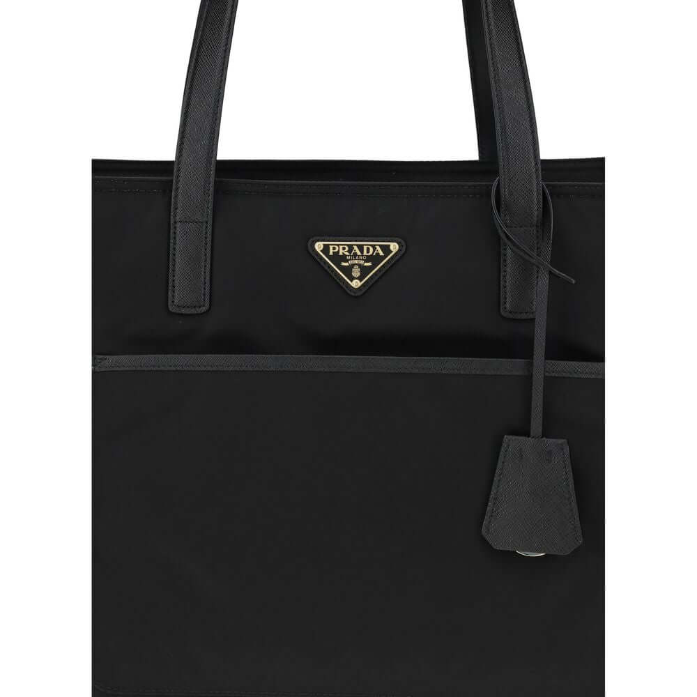 Black Nylon Shoulder BagRe-Nylon Re-Edition 1978 Shoulder Bag by Prada, two flat handles, concealed top zipper closure, interior lining with printed logo, front panel patch pocket, iconic triangular enameled signature brand plaque applied to front. Season
