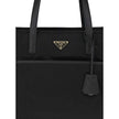 Black Nylon Shoulder BagRe-Nylon Re-Edition 1978 Shoulder Bag by Prada, two flat handles, concealed top zipper closure, interior lining with printed logo, front panel patch pocket, iconic triangular enameled signature brand plaque applied to front. Season