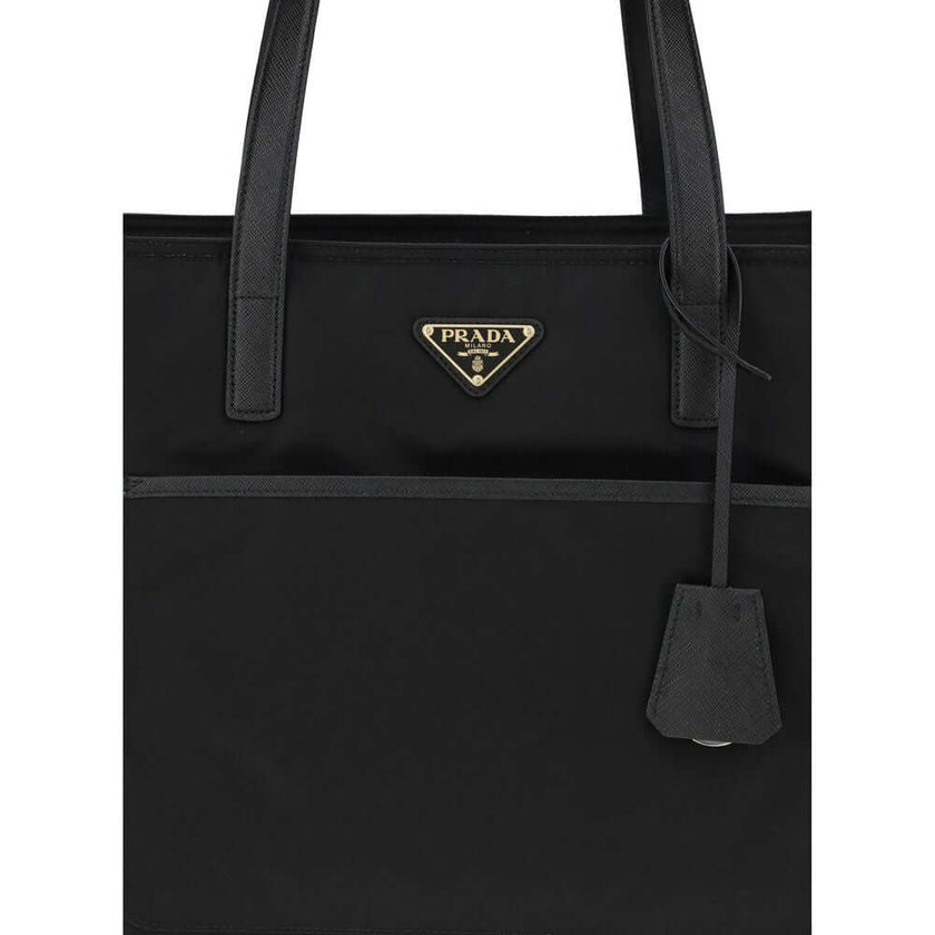 Black Nylon Shoulder BagRe-Nylon Re-Edition 1978 Shoulder Bag by Prada, two flat handles, concealed top zipper closure, interior lining with printed logo, front panel patch pocket, iconic triangular enameled signature brand plaque applied to front. Season
