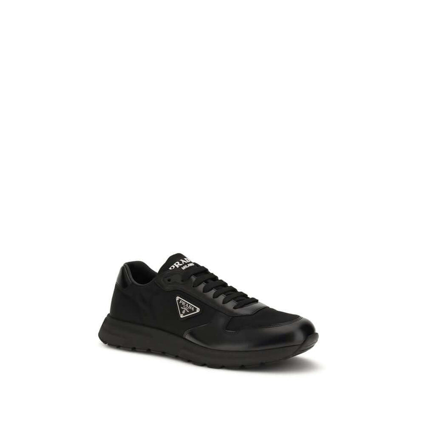 Black Recycled Polyamide Athletic SneakersPrax 01 Sneakers by Prada, made of Re-Nylon and brushed leather, combine contemporary style and innovative materials. Equipped with laces, they feature an enameled triangle logo on the upper and screen-printed Pra