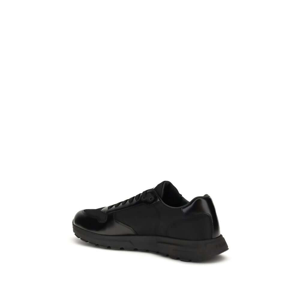 Black Recycled Polyamide Athletic SneakersPrax 01 Sneakers by Prada, made of Re-Nylon and brushed leather, combine contemporary style and innovative materials. Equipped with laces, they feature an enameled triangle logo on the upper and screen-printed Pra