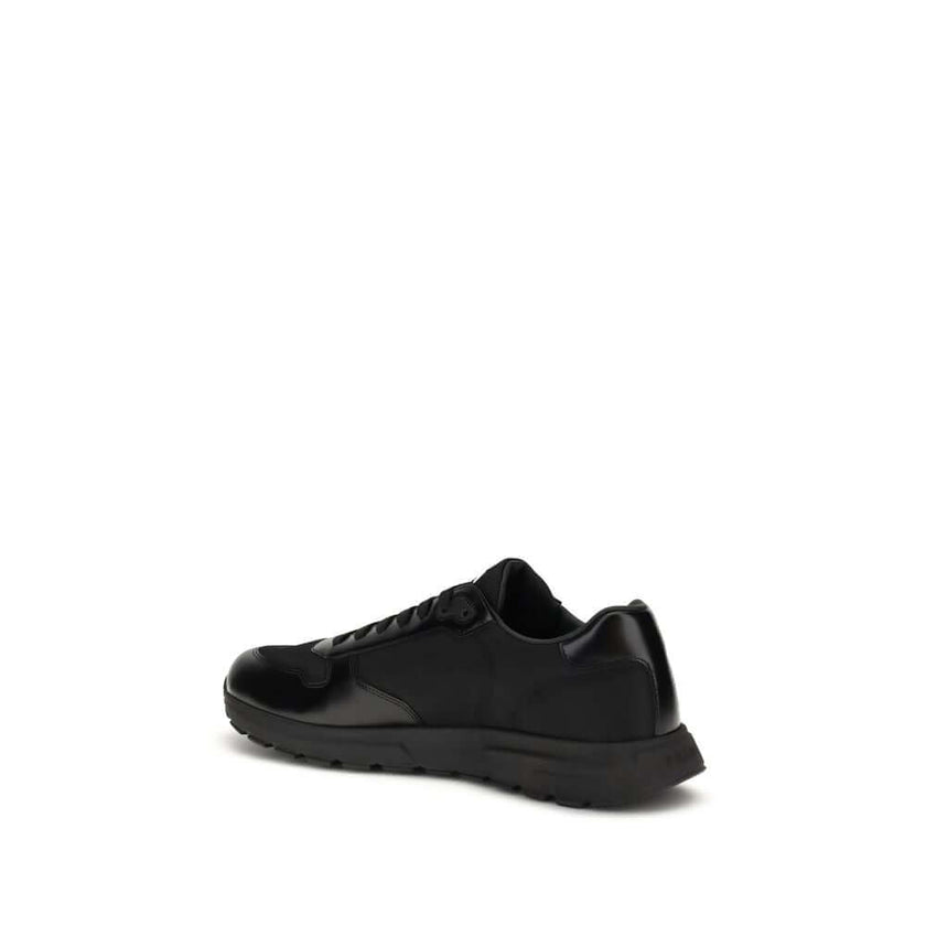 Black Recycled Polyamide Athletic SneakersPrax 01 Sneakers by Prada, made of Re-Nylon and brushed leather, combine contemporary style and innovative materials. Equipped with laces, they feature an enameled triangle logo on the upper and screen-printed Pra