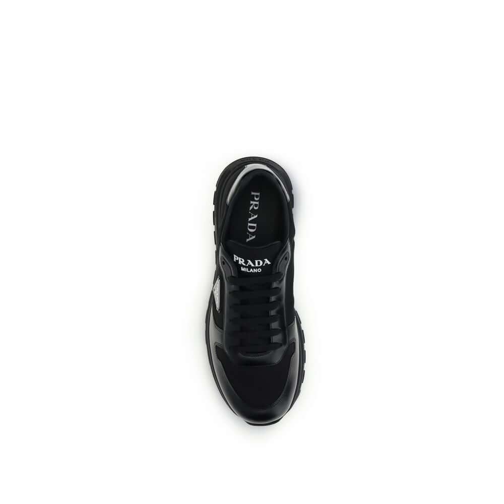 Black Recycled Polyamide Athletic SneakersPrax 01 Sneakers by Prada, made of Re-Nylon and brushed leather, combine contemporary style and innovative materials. Equipped with laces, they feature an enameled triangle logo on the upper and screen-printed Pra