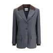 Gray Fleece Wool BlazerMiu Miu’s striped Blazer combines classic elegance with contemporary details. The single-breasted design features two welt flap pockets, a breast pocket and peaked lapels, while the ribbed collar and double sleeves add a touch of or
