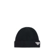 Black Fleece Wool BeaniePrada’s beanie Hat with logo plaque is an essential accessory with distinctive character. Made with ribbed lapels for a snug and comfortable fit, it is embellished with the iconic triangular side plaque, a symbol of the brand’s min