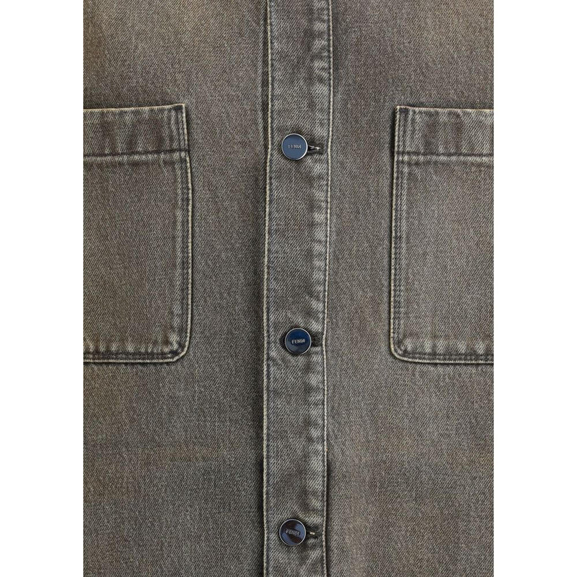 Gray Denim ShirtThe overdyed Denim Shirt by Fendi embodies a bold, contemporary spirit. Designed with dropped shoulders and chest patch pockets, it balances casual ease with refined craftsmanship. The front is fastened with logo-engraved metal buttons, ad