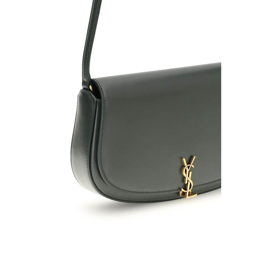 Green Calf Leather Bos Taurus Shoulder BagThe Voltaire mini Shoulder Bag by Saint Laurent is an elegant crescent-shaped bag crafted from calfskin with a lightly polished finish. Bronze-colored metallic parts add a warm, vintage touch, while the Cassandre