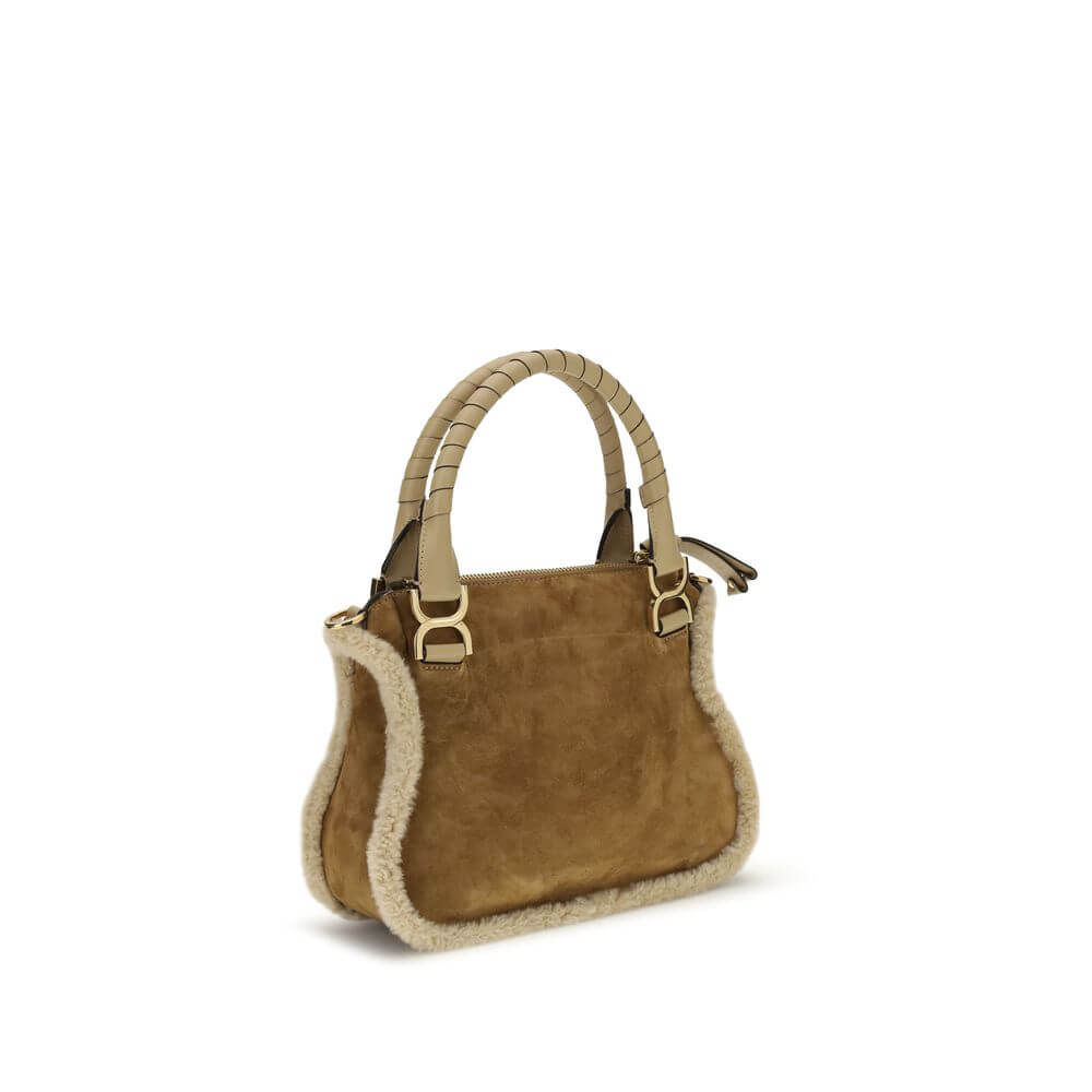 Beige Leather HandbagMarcie small Handbag by Chloé, made of suede and shearling leather, is a perfect balance of elegance and functionality. It can be carried by hand, over the shoulder or over the shoulder thanks to the removable leather strap via hooks.