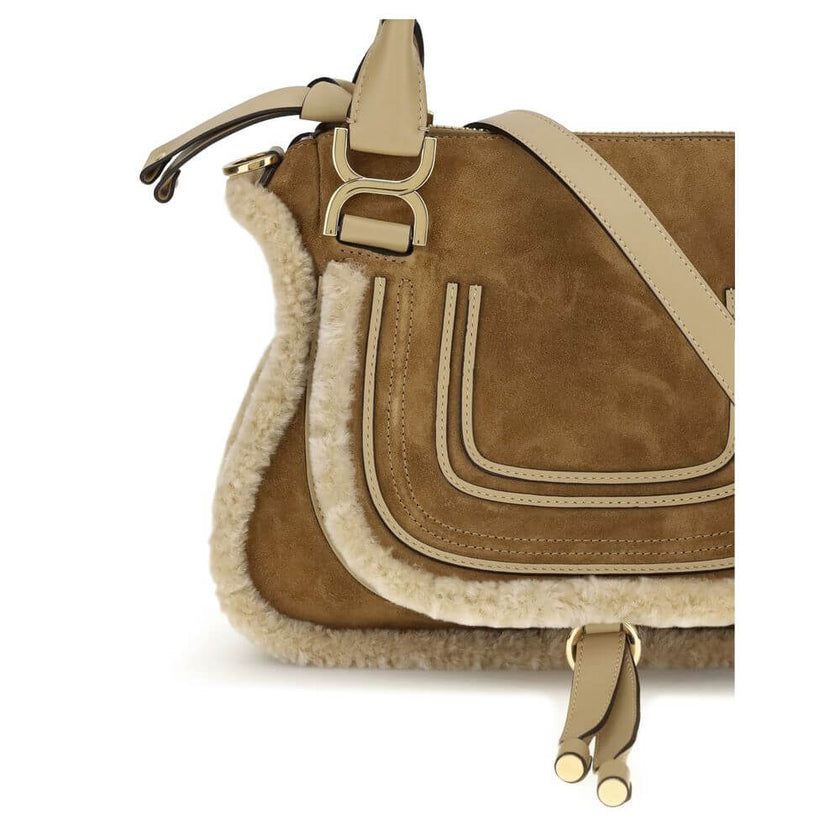 Beige Leather HandbagMarcie small Handbag by Chloé, made of suede and shearling leather, is a perfect balance of elegance and functionality. It can be carried by hand, over the shoulder or over the shoulder thanks to the removable leather strap via hooks.