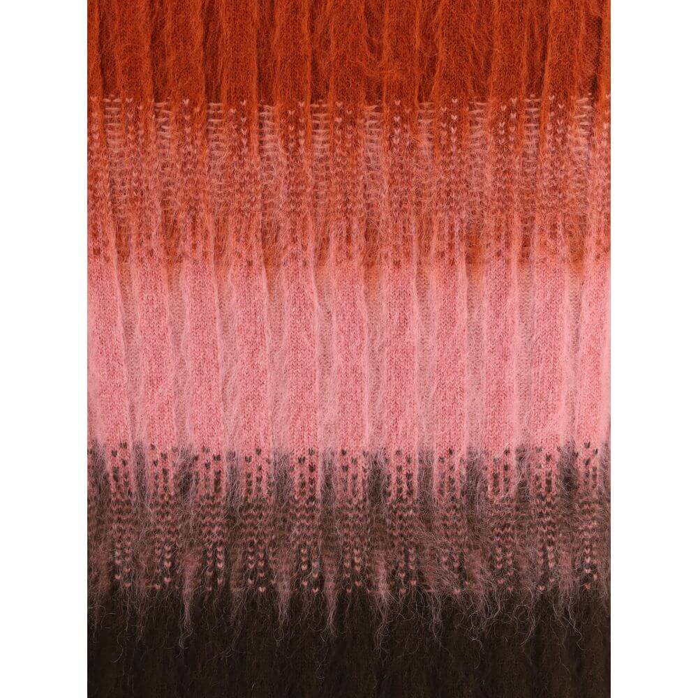 Multicolor Mohair Midi SkirtThe Mohair and Wool Midi Skirt elegantly embodies Fendi’s artisanal tradition and refined aesthetic. The high waist and fitted silhouette, slightly flared at the hem, define a feminine and balanced shape. Crafted in ribbed vani