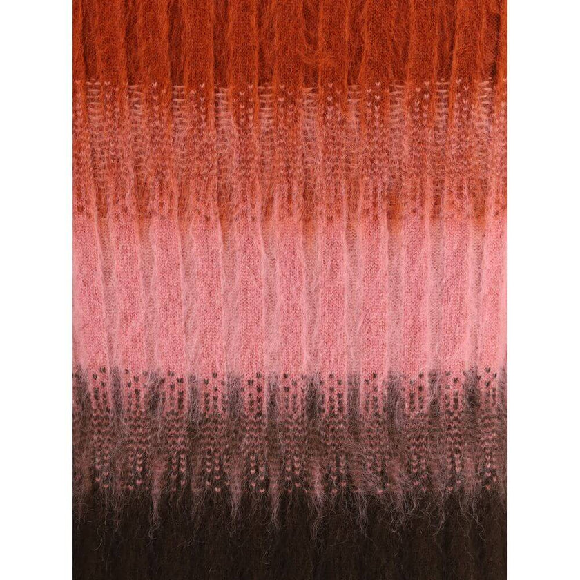 Multicolor Mohair Midi SkirtThe Mohair and Wool Midi Skirt elegantly embodies Fendi’s artisanal tradition and refined aesthetic. The high waist and fitted silhouette, slightly flared at the hem, define a feminine and balanced shape. Crafted in ribbed vani