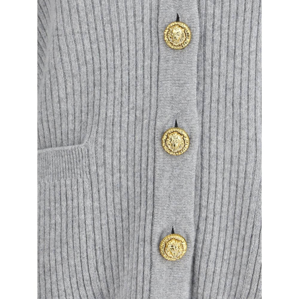Gray Fleece Wool CardiganThe long cashmere Cardigan by Balmain represents the perfect fusion of comfort and sophistication, typical of the brand. The soft, elongated line is defined by the deep V-neckline and ribbed edges that emphasize its structure with