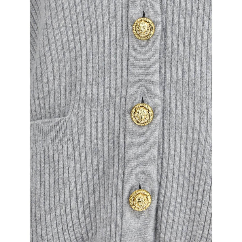 Gray Fleece Wool CardiganThe long cashmere Cardigan by Balmain represents the perfect fusion of comfort and sophistication, typical of the brand. The soft, elongated line is defined by the deep V-neckline and ribbed edges that emphasize its structure with