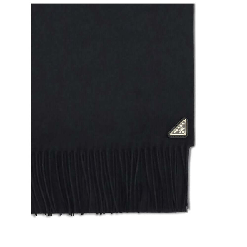 Silk and cashmere ScarfThe silk and cashmere Scarf by Prada is an elegant and lightweight accessory, perfect for adding a touch of sophistication to any look. Finished with frayed edges, it is embellished with the characteristic enameled metal logo triang