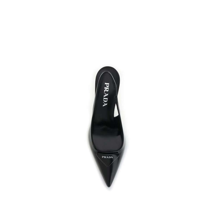 Black Leather High Heel PumpsThe leather slingback Pumps by Prada express contemporary elegance with clean lines and iconic details. Made of smooth leather, they are embellished with the classic tonal leather triangle logo on the front. The pointed toe mo