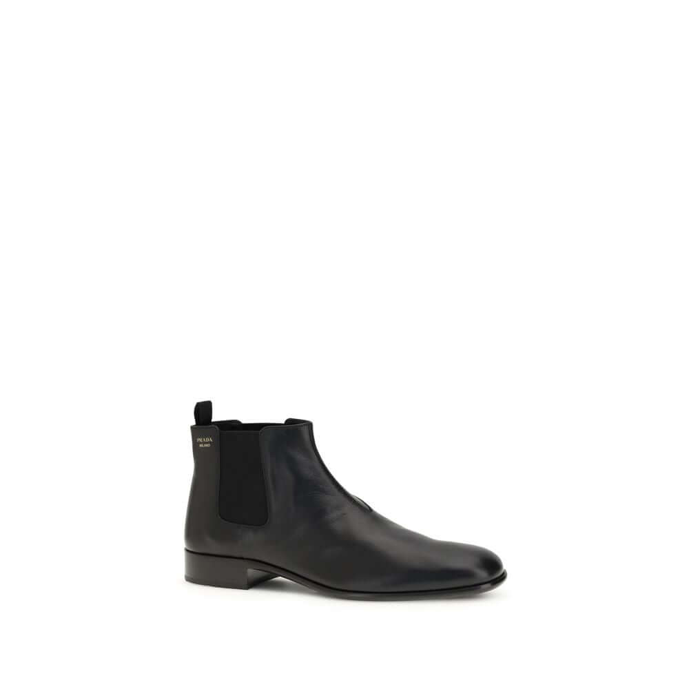 Black Leather Ankle BootsThe leather Ankle Boots by Prada reinterpret a wardrobe classic with essential lines and distinctive details. The upper is enriched with elastic side inserts and a rear pull-on for a quick and practical fit. The leather lining ens