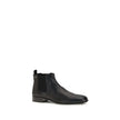Black Leather Ankle BootsThe leather Ankle Boots by Prada reinterpret a wardrobe classic with essential lines and distinctive details. The upper is enriched with elastic side inserts and a rear pull-on for a quick and practical fit. The leather lining ens