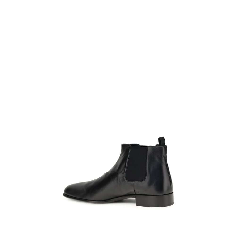 Black Leather Ankle BootsThe leather Ankle Boots by Prada reinterpret a wardrobe classic with essential lines and distinctive details. The upper is enriched with elastic side inserts and a rear pull-on for a quick and practical fit. The leather lining ens