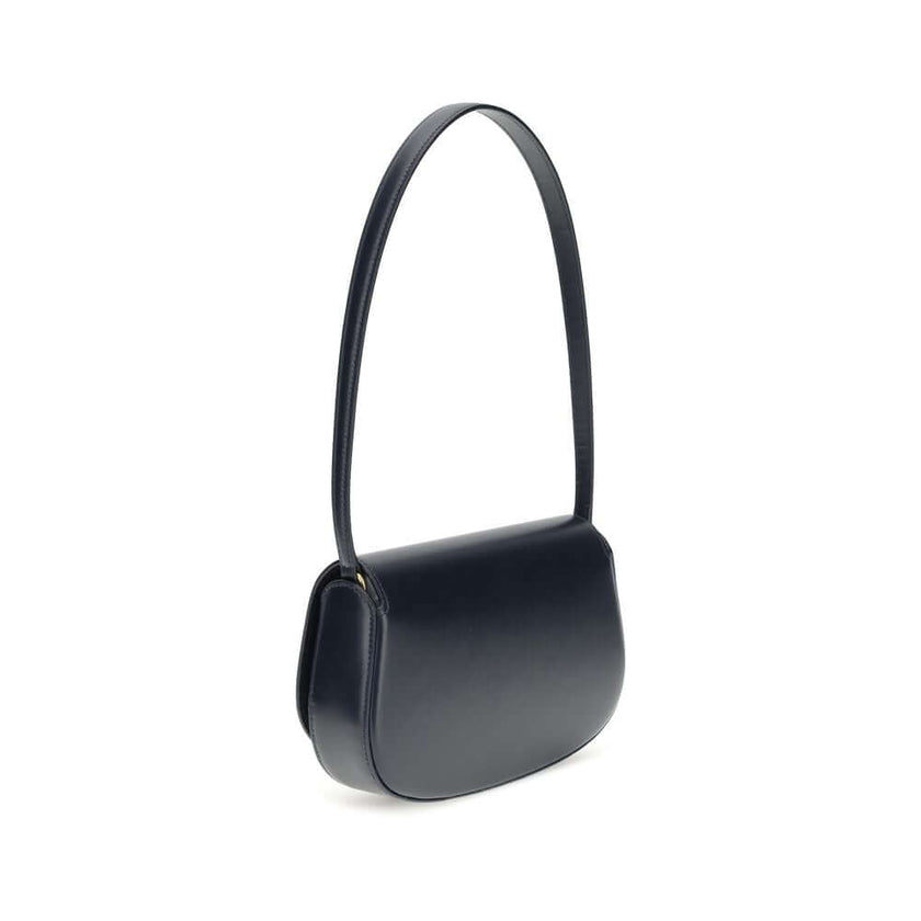 Blue Calf Leather Bos Taurus Shoulder BagThe Voltaire mini Shoulder Bag by Saint Laurent is an elegant crescent-shaped bag crafted from calfskin with a lightly polished finish. Bronze-colored metallic parts add a warm, vintage touch, while the Cassandre m