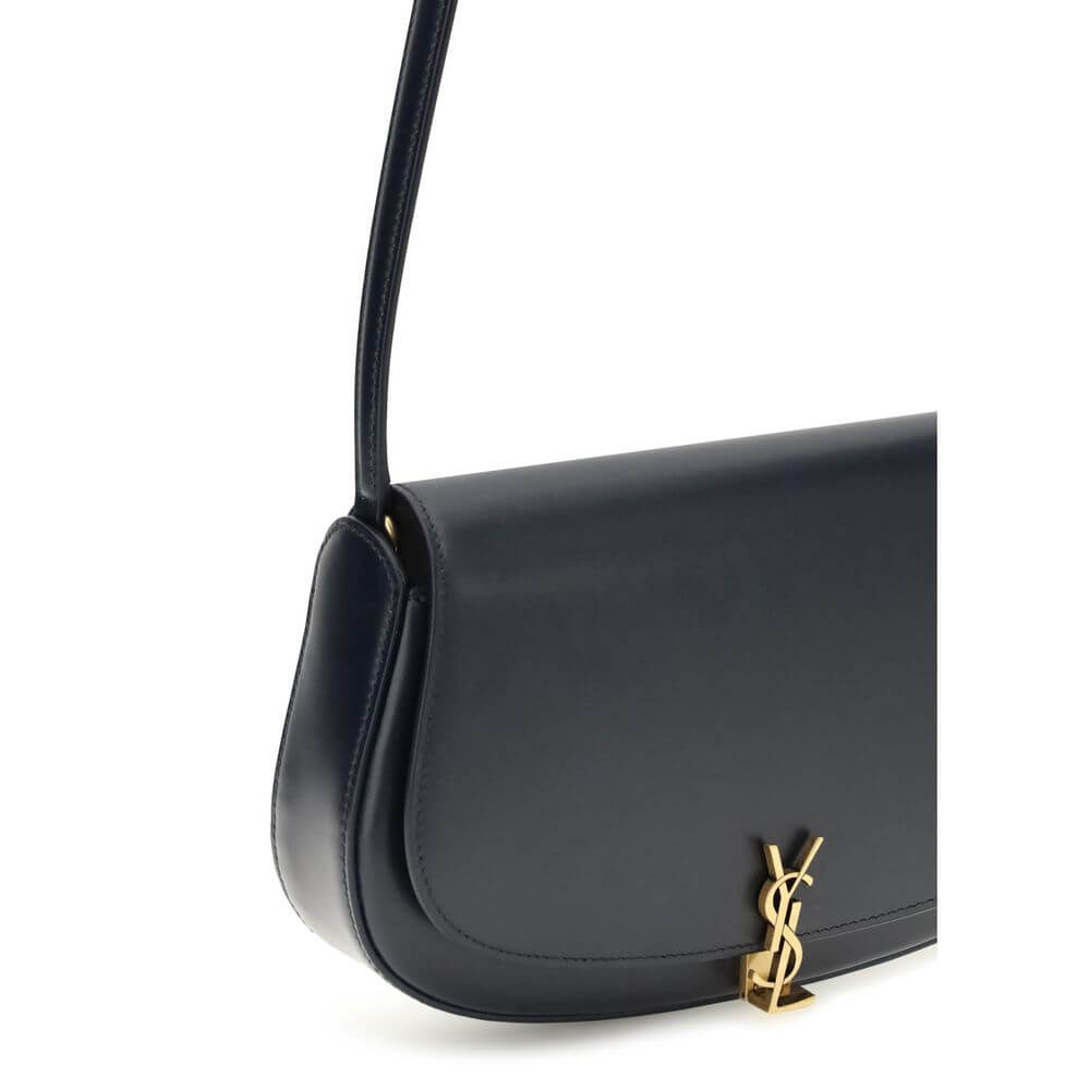 Blue Calf Leather Bos Taurus Shoulder BagThe Voltaire mini Shoulder Bag by Saint Laurent is an elegant crescent-shaped bag crafted from calfskin with a lightly polished finish. Bronze-colored metallic parts add a warm, vintage touch, while the Cassandre m