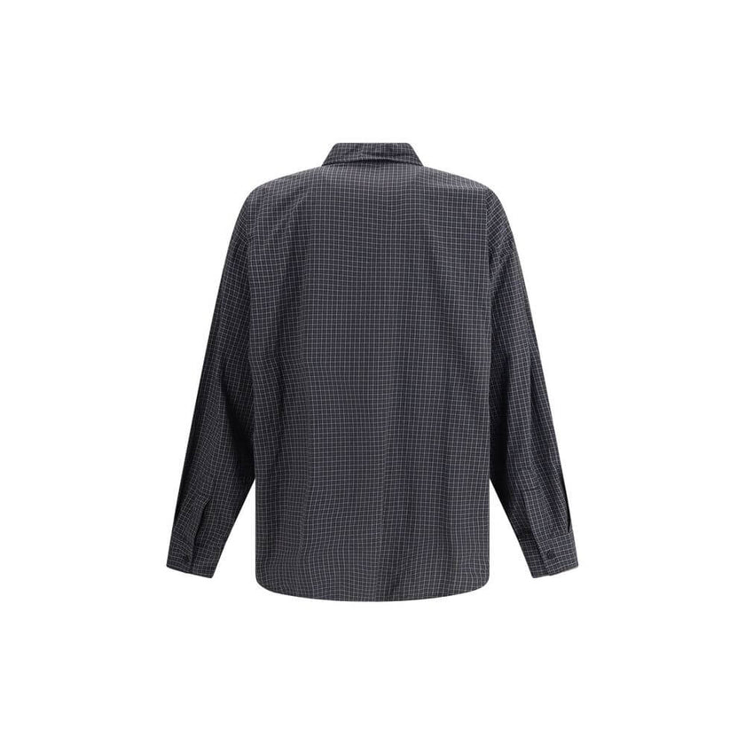 Black Wool Pattern ShirtThe oversized checked Shirt by Balenciaga is crafted from checked wool-blend flannel, reimagining a classic silhouette with a modern oversized cut. It features a button-down collar, seven front buttons engraved with Balenciaga, a c