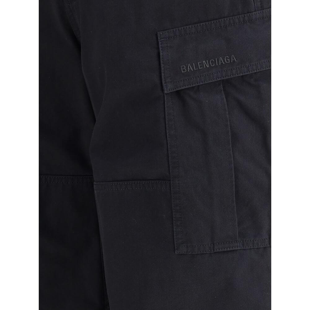 Black Cotton Cargo PantsThe Cargo Pants by Balenciaga represent the brand’s contemporary vision, where urban aesthetics meet the balance between form and function. Made of soft left-hand denim, they wrap with structure and comfort, defining a silhouette w