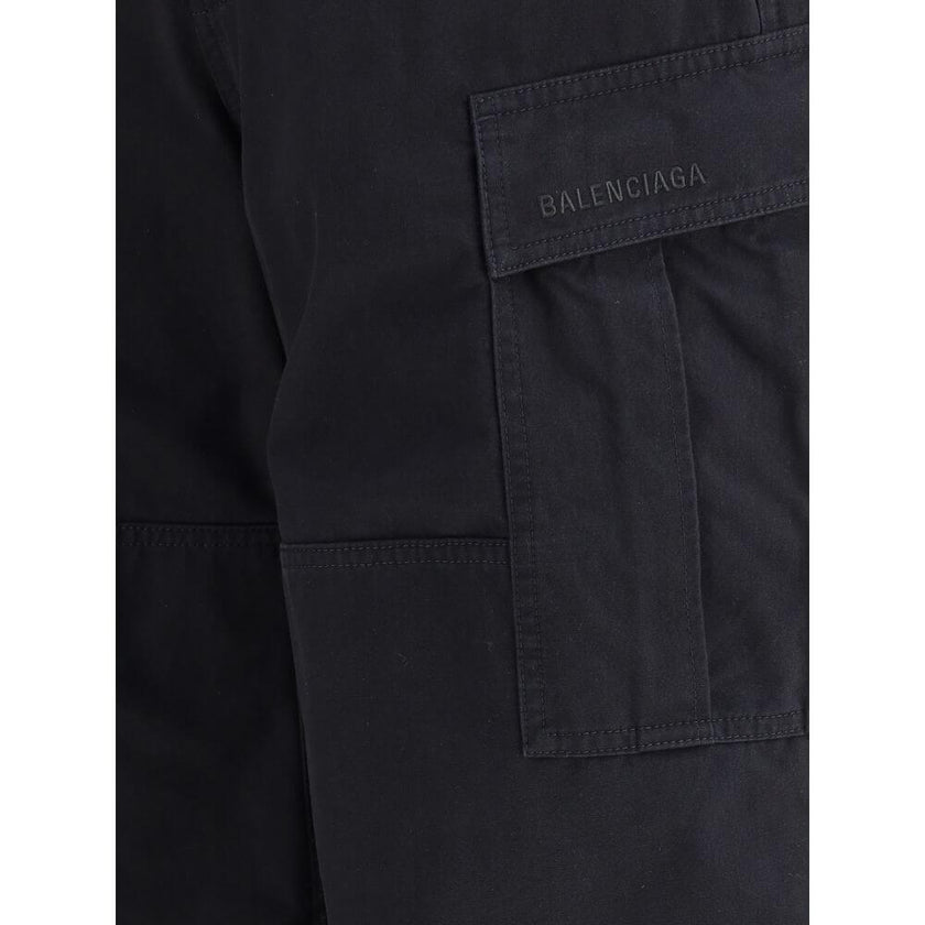 Black Cotton Cargo PantsThe Cargo Pants by Balenciaga represent the brand’s contemporary vision, where urban aesthetics meet the balance between form and function. Made of soft left-hand denim, they wrap with structure and comfort, defining a silhouette w