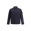 Blue Cotton Dress ShirtThe Stone Island Overshirt, crafted from 100% black cotton, is a versatile essential that blends functionality with contemporary style. Featuring a button fastening, two chest patch pockets, and the iconic logo patch on the left sle