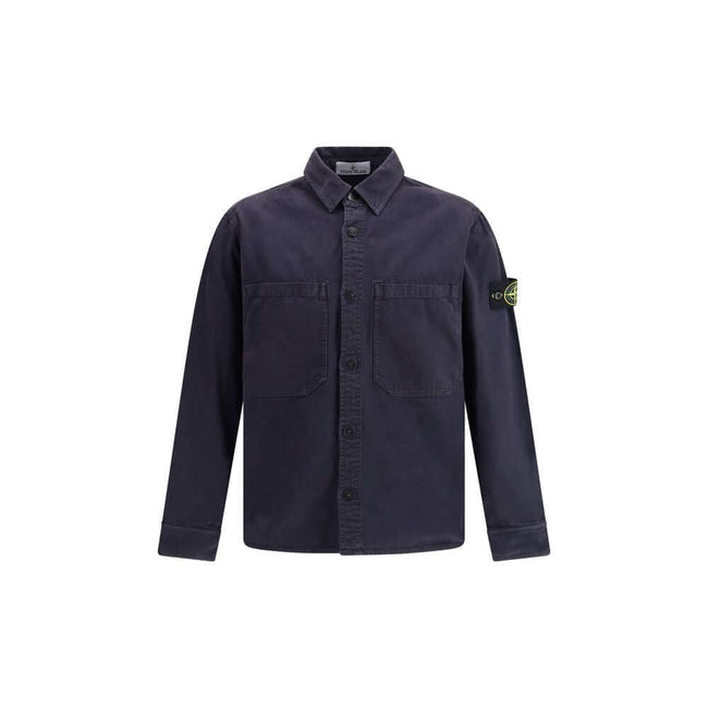 Blue Cotton Dress ShirtThe Stone Island Overshirt, crafted from 100% black cotton, is a versatile essential that blends functionality with contemporary style. Featuring a button fastening, two chest patch pockets, and the iconic logo patch on the left sle