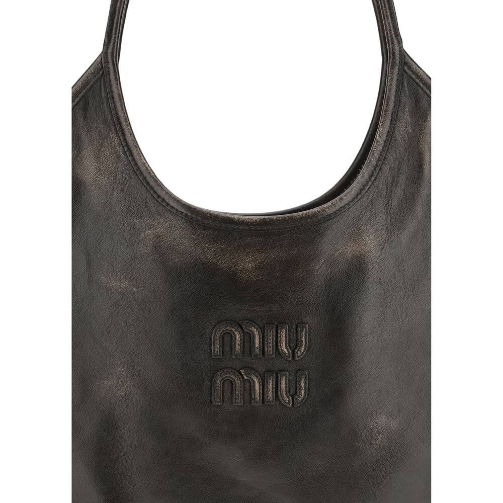 Brown Calf Leather Bos Taurus Shoulder BagIvy Shoulder Bag by Miu Miu made of soft, worn-effect leather features a double flat handle that allows comfortable shoulder carrying .The brand’s logo stands out on the front adding an iconic touch. The unlined i