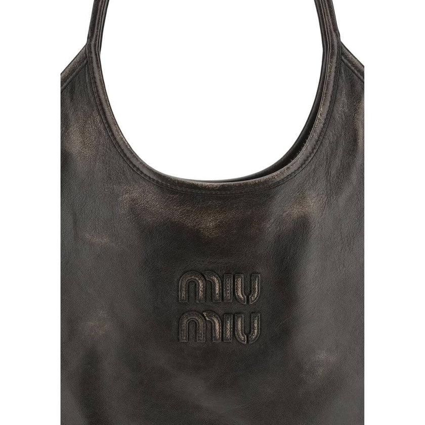 Brown Calf Leather Bos Taurus Shoulder BagIvy Shoulder Bag by Miu Miu made of soft, worn-effect leather features a double flat handle that allows comfortable shoulder carrying .The brand’s logo stands out on the front adding an iconic touch. The unlined i