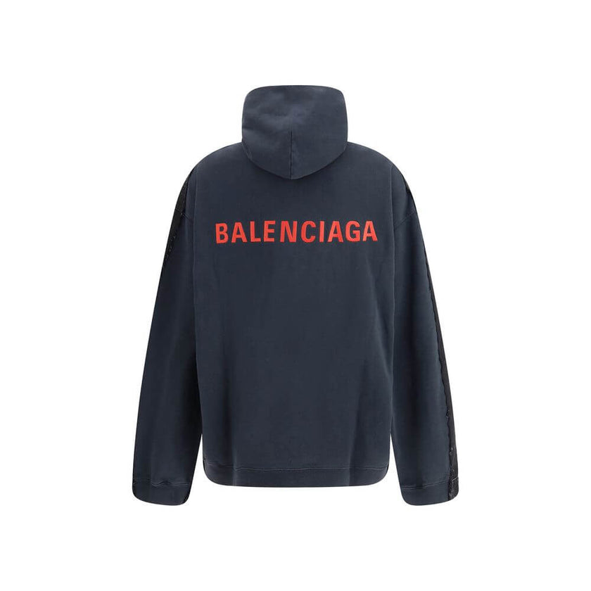 Black Cotton Denim JacketThe Layered Jacket by Balenciaga redefines layering with a modern twist. The front panel is crafted in denim, while the back and hood are made of soft sweatshirt fabric for a relaxed contrast. It features a classic collar, button-