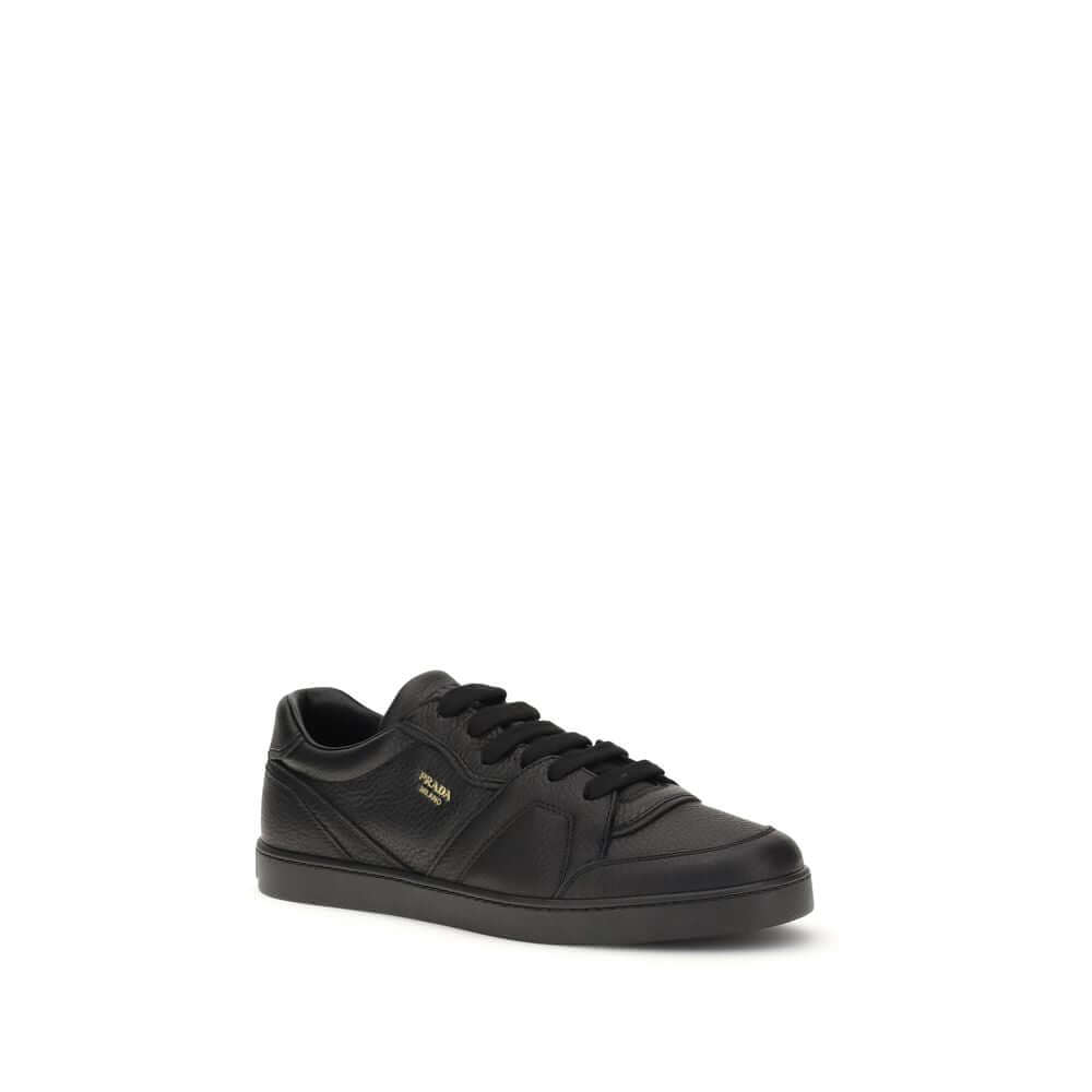 Black Calf Leather Bos Taurus SneakersLeather Sneakers by Prada combine elegance and urban style in an essential and sophisticated design. Featuring a lace-up closure and a flat sole, they feature a paneled pattern that adds depth to the profile. The gold
