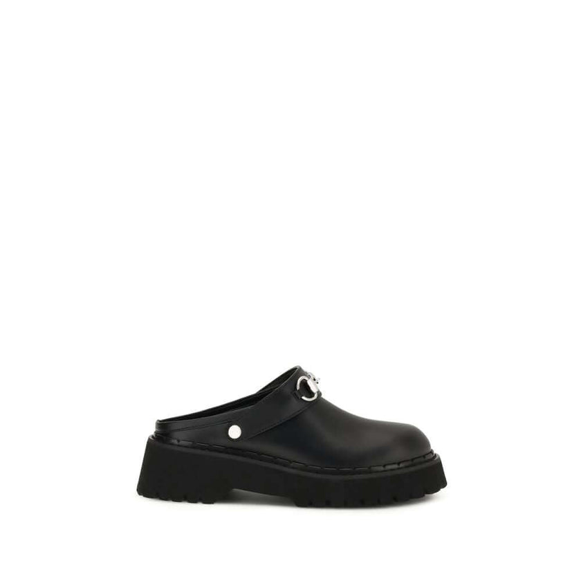 Black Leather MulesThe Mule with Horsebit by Gucci pays tribute to the House’s equestrian heritage, where the Horsebit detail has become both a historical and contemporary emblem. Crafted in supple leather, it is finished with silver-toned hardware, a rub