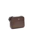 Brown Calf Leather Bos Taurus Shoulder BagPrada’s Logo Shoulder Bag is an elegant and functional accessory made of fine calfskin leather. Featuring a zippered closure and an adjustable buckled shoulder strap, it has metal hardware that enhances its charac