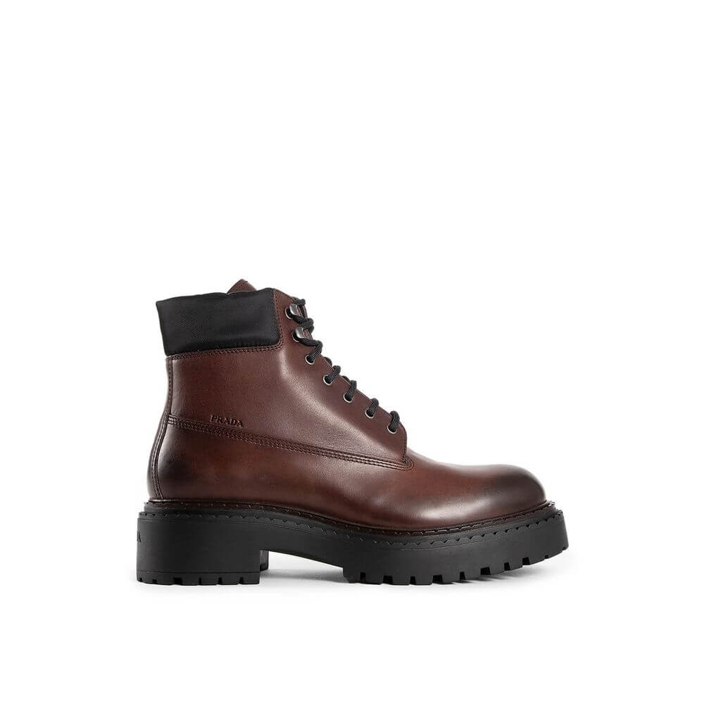 Brown Calfskin Lace-Up BootsDescription: – Composition: 100% calf leather – Inner: Leather – Insole: Leather – Sole: Rubber – Round toe – Front lace-up closure – Side logo detail – Metal eyelets – Re-Nylon accents – Stamped notch effect sole – Hot-stamped