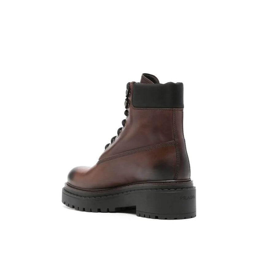 Brown Calfskin Lace-Up BootsDescription: – Composition: 100% calf leather – Inner: Leather – Insole: Leather – Sole: Rubber – Round toe – Front lace-up closure – Side logo detail – Metal eyelets – Re-Nylon accents – Stamped notch effect sole – Hot-stamped