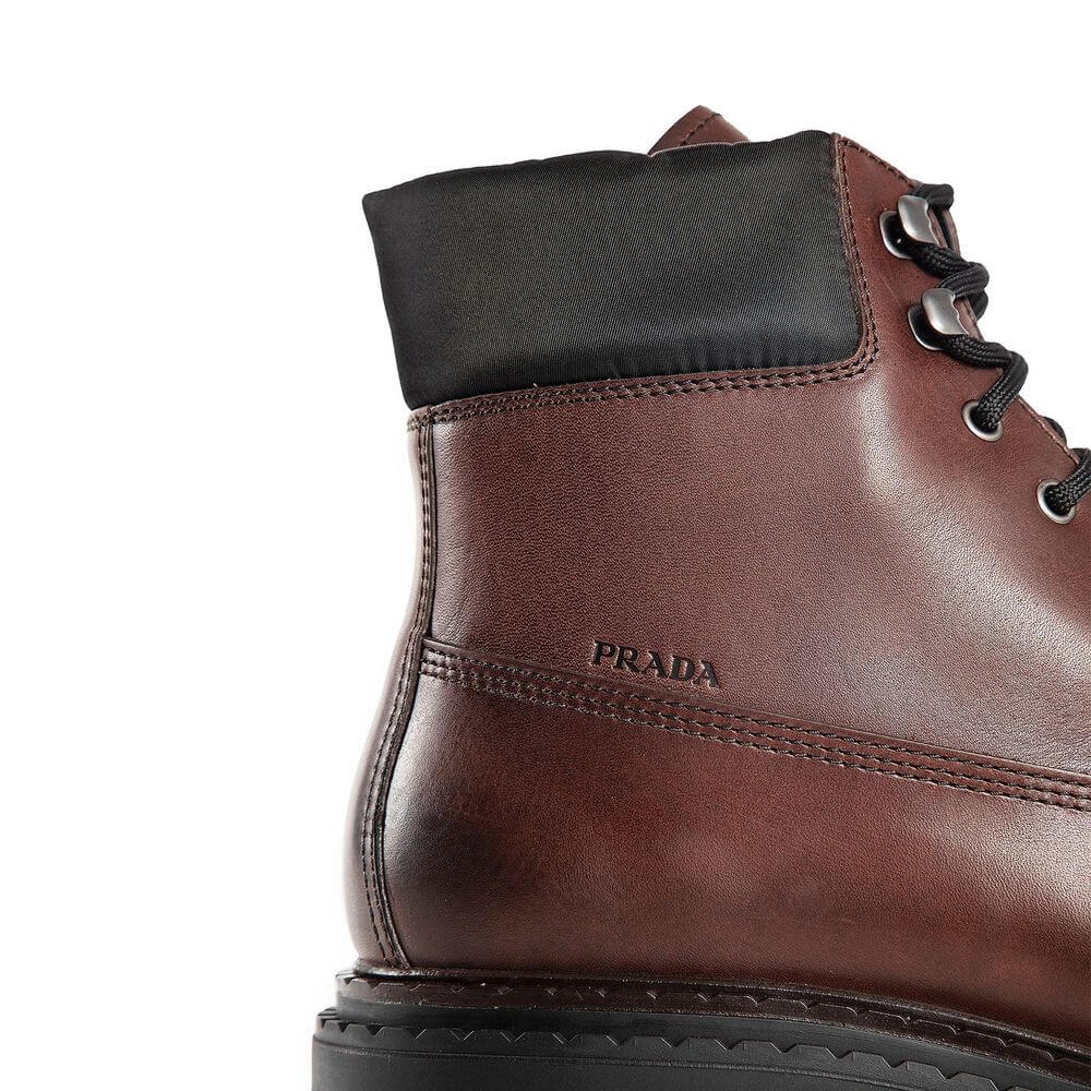 Brown Calfskin Lace-Up BootsDescription: – Composition: 100% calf leather – Inner: Leather – Insole: Leather – Sole: Rubber – Round toe – Front lace-up closure – Side logo detail – Metal eyelets – Re-Nylon accents – Stamped notch effect sole – Hot-stamped