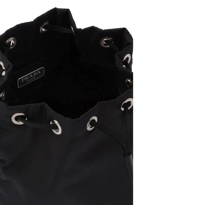 Black Nylon HandbagDescription: – Composition: 100% Nylon – Leather detail – Width 10 cm – Drawstring closure – Length 19 cm – Height 22 cm – Front enamelled metal triangle logo – No handle – No shoulder strap – Made in Turkey – Gender: WOMEN –Black Nylon