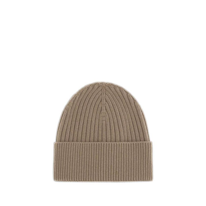 Beige Merino Wool BeanieBeanie Hat by Moncler Grenoble combines functionality and style in an essential cold-weather accessory. Made with ribbed fabrication, it offers a snug and comfortable fit. The Moncler Grenoble logo sewn on the front adds a distinct