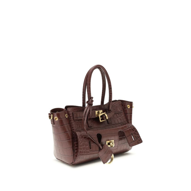 Bordeaux Calf Leather Bos Taurus Shoulder BagBel Air mini Shoulder Bag by Balenciaga, is made of calfskin leather with crocodile processing, combining sophistication and iconic design. The carry-all model features two handles joined by a clip and an adjus