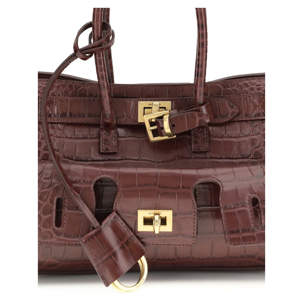 Bordeaux Calf Leather Bos Taurus Shoulder BagBel Air mini Shoulder Bag by Balenciaga, is made of calfskin leather with crocodile processing, combining sophistication and iconic design. The carry-all model features two handles joined by a clip and an adjus