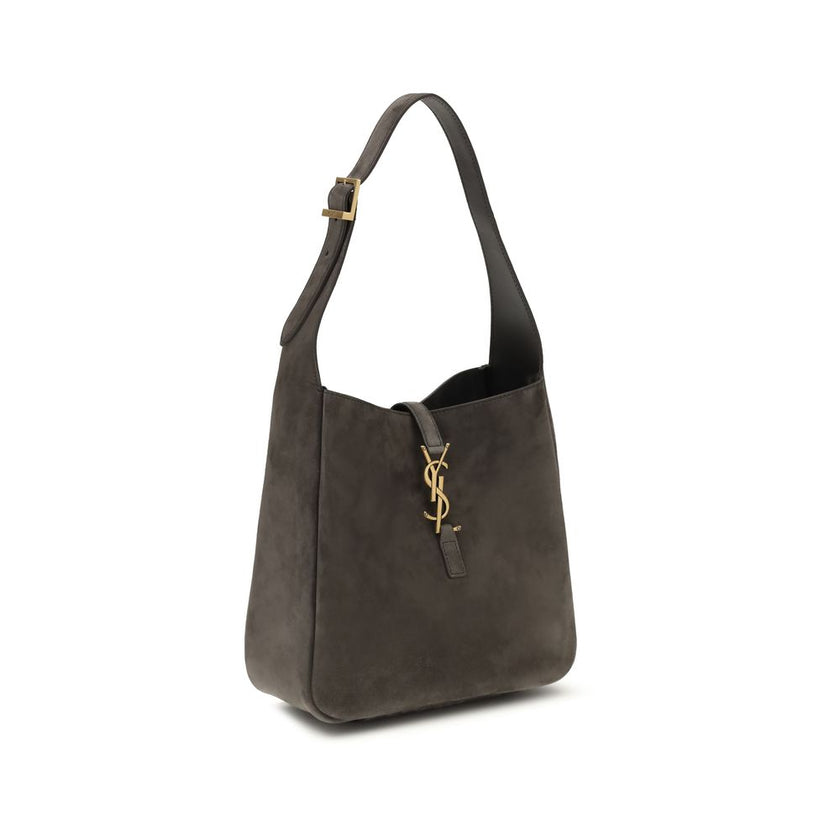 Gray Calf Leather Bos Taurus Shoulder BagThe Le 5 à 7 suede Shoulder Bag by Saint Laurent is a sophisticated and practical design perfect for any occasion. The bag features a removable zippered clutch, ideal for keeping smaller items in order. The leather